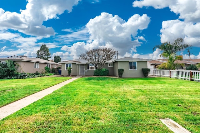 ranch-style house featuring a front lawn, fence, and stucco siding