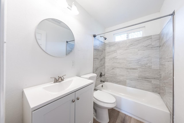 bathroom featuring bathing tub / shower combination, wood finished floors, vanity, and toilet