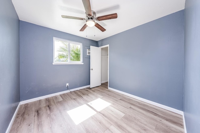 unfurnished room featuring a ceiling fan, baseboards, and wood finished floors