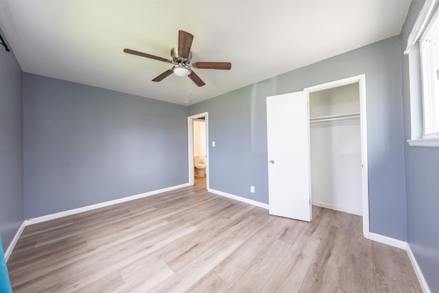 unfurnished bedroom featuring a closet, a ceiling fan, baseboards, and wood finished floors