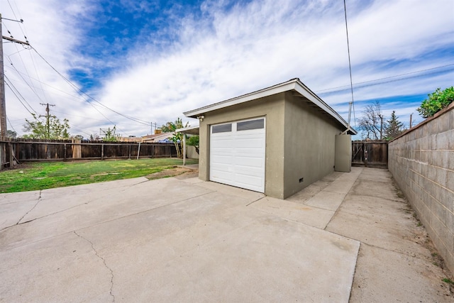 detached garage with fence and driveway