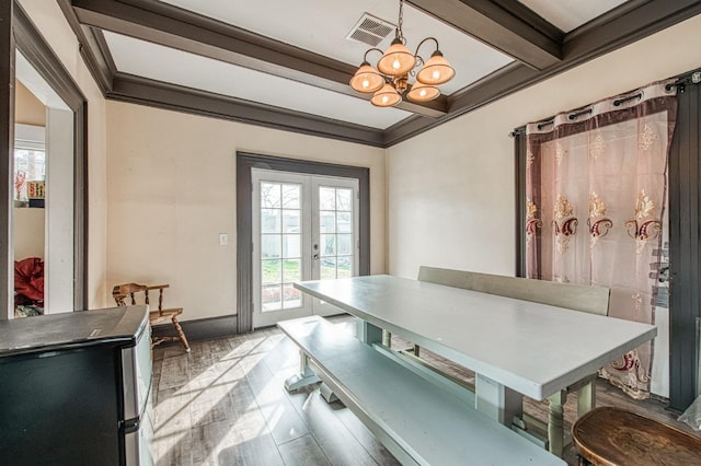 dining room featuring french doors, crown molding, visible vents, an inviting chandelier, and beamed ceiling