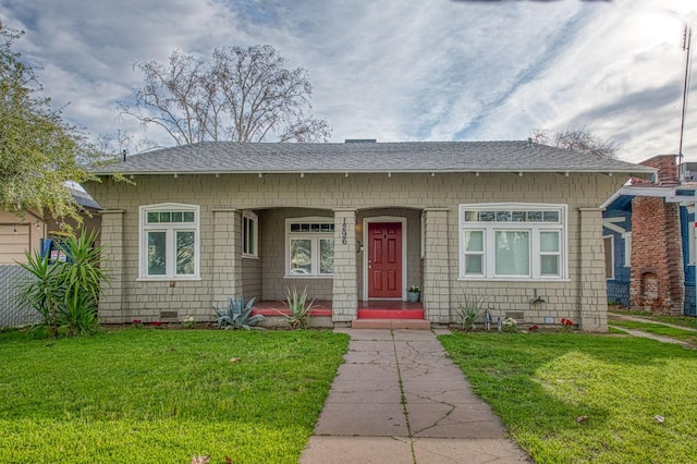 bungalow-style house with roof with shingles, a front lawn, and crawl space