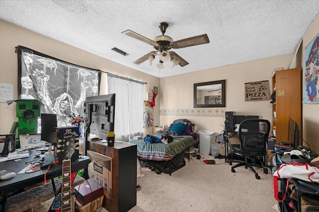 bedroom with a ceiling fan, visible vents, carpet flooring, and a textured ceiling