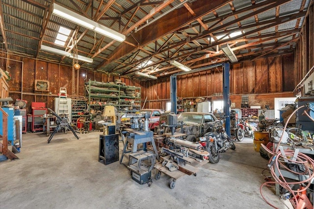 garage with a workshop area and metal wall