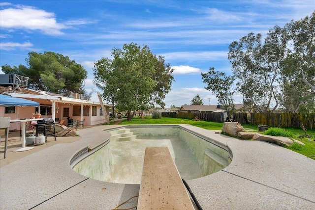 view of swimming pool with a fenced backyard, a fenced in pool, and a patio