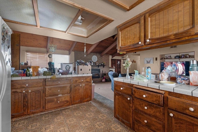 bathroom featuring vaulted ceiling with beams, wooden ceiling, and a fireplace