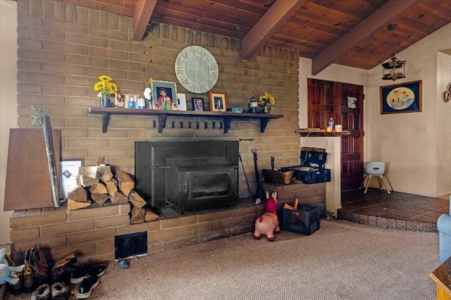 living room with visible vents, lofted ceiling with beams, wood ceiling, a wood stove, and carpet flooring