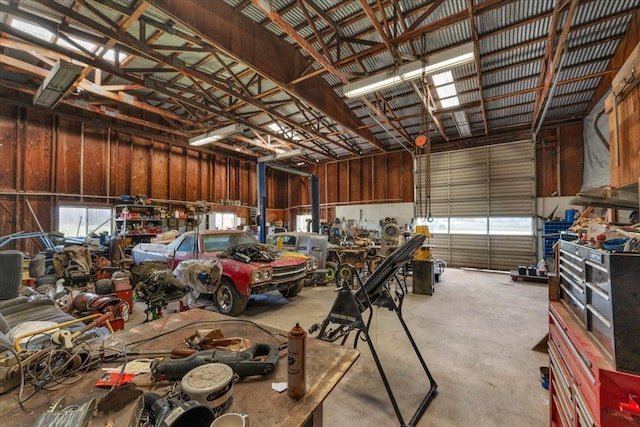 garage with a workshop area and metal wall