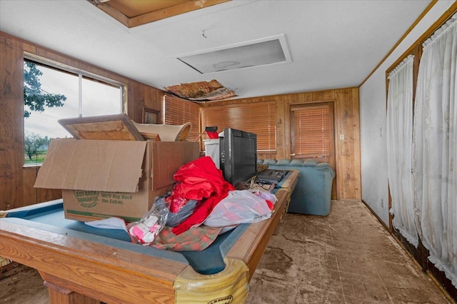 interior space featuring wood walls and attic access