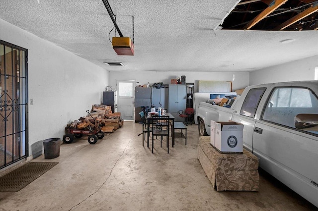 garage with visible vents and a garage door opener