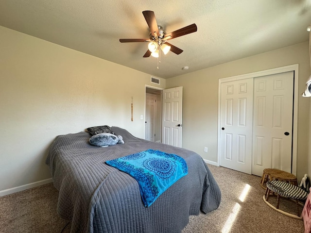 bedroom with carpet floors, baseboards, ceiling fan, and a textured ceiling