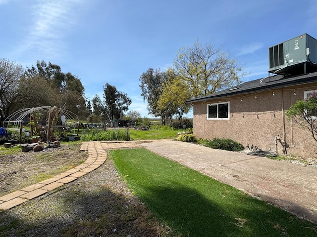view of yard with central air condition unit