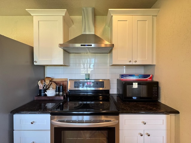 kitchen with wall chimney range hood, white cabinets, stainless steel electric range oven, and decorative backsplash