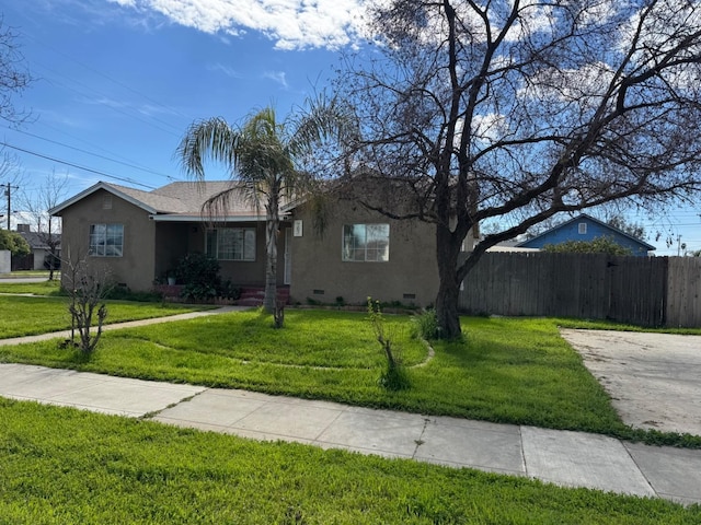 ranch-style house with a front lawn, crawl space, fence, and stucco siding