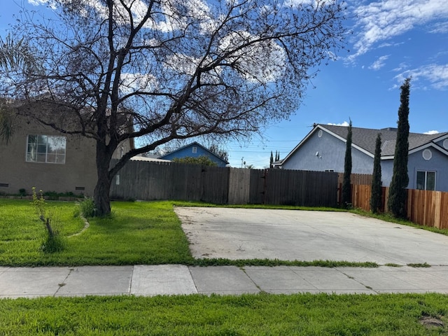 exterior space featuring concrete driveway and fence