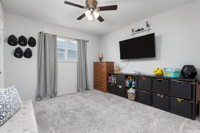 interior space with a ceiling fan and a textured ceiling