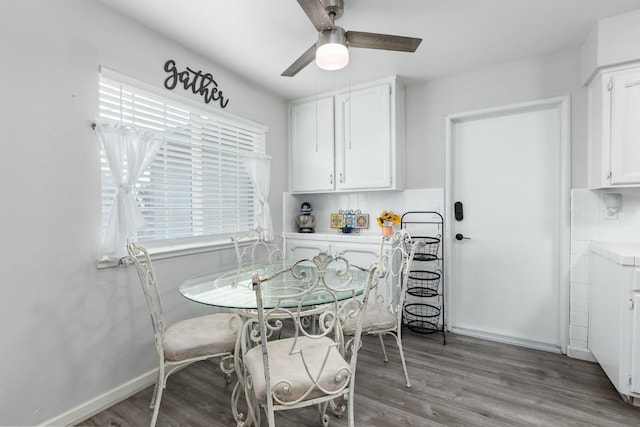 dining room featuring a ceiling fan, a healthy amount of sunlight, and wood finished floors