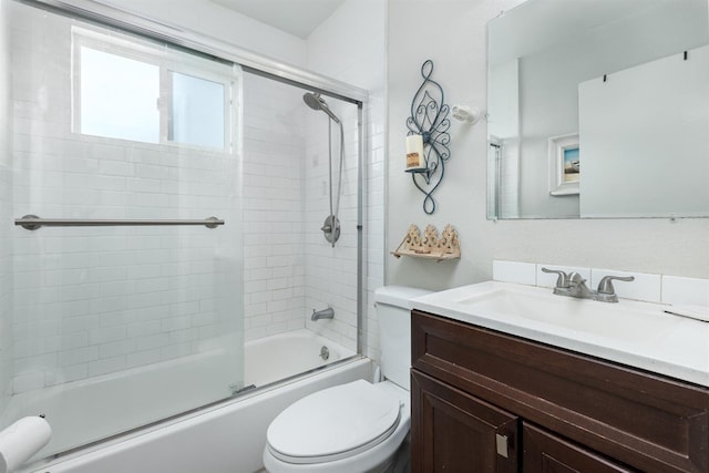 full bath featuring toilet, bath / shower combo with glass door, and vanity