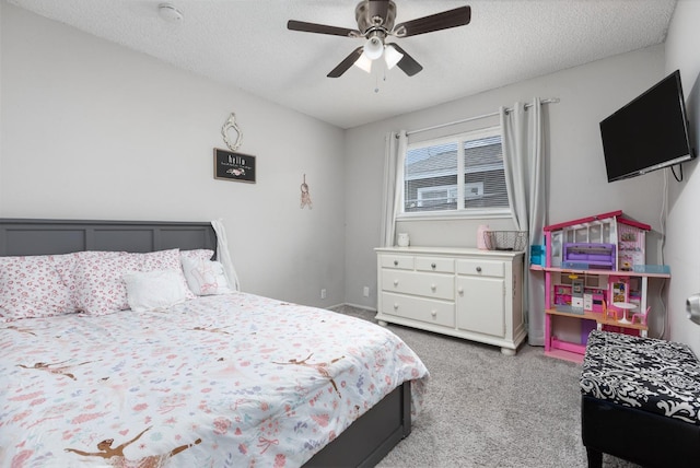 bedroom with ceiling fan, a textured ceiling, and light colored carpet