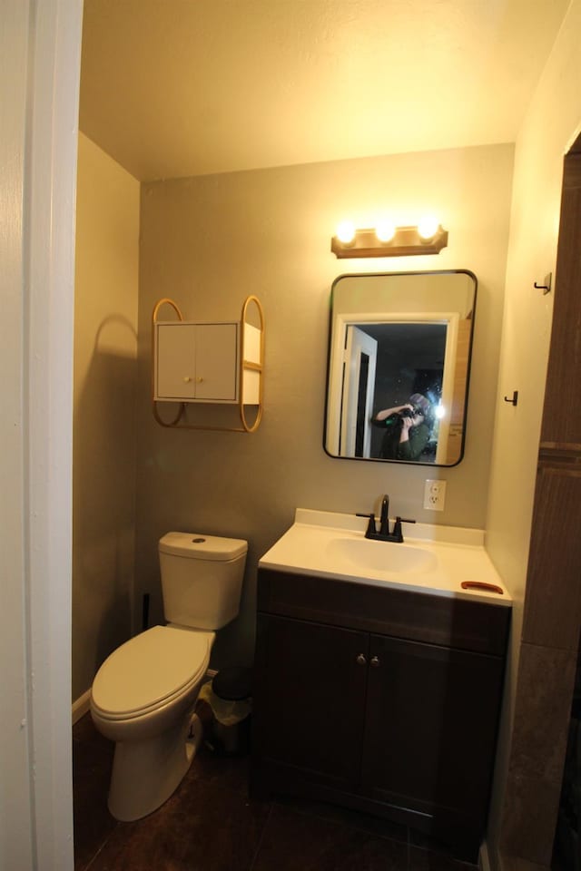 bathroom featuring vanity, toilet, and tile patterned floors