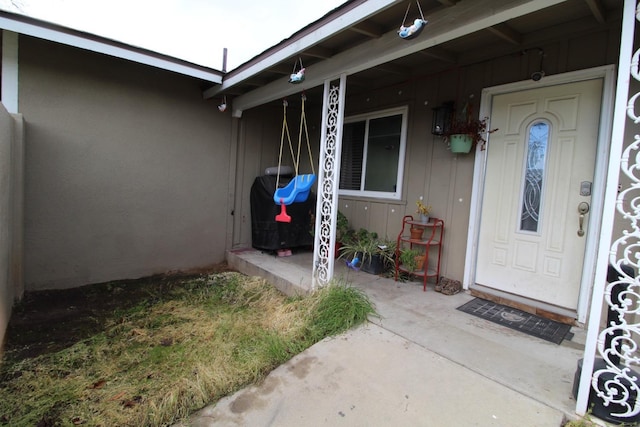 view of exterior entry with covered porch