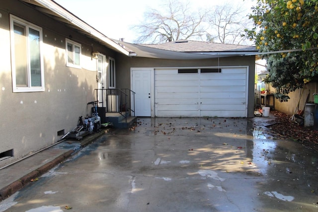 garage with concrete driveway