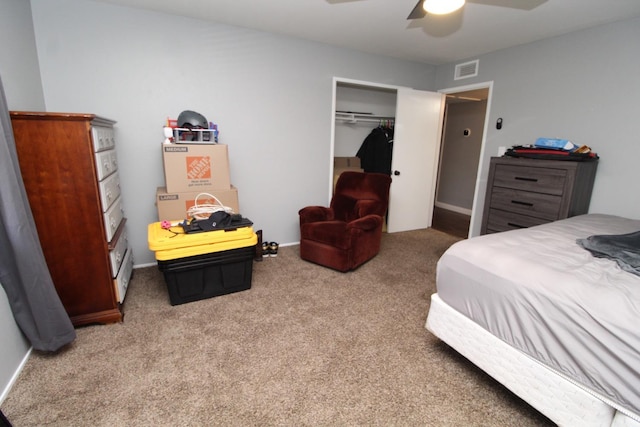 carpeted bedroom featuring a ceiling fan, a closet, visible vents, and baseboards