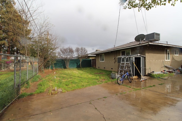 view of yard featuring central air condition unit, a patio area, and a fenced backyard