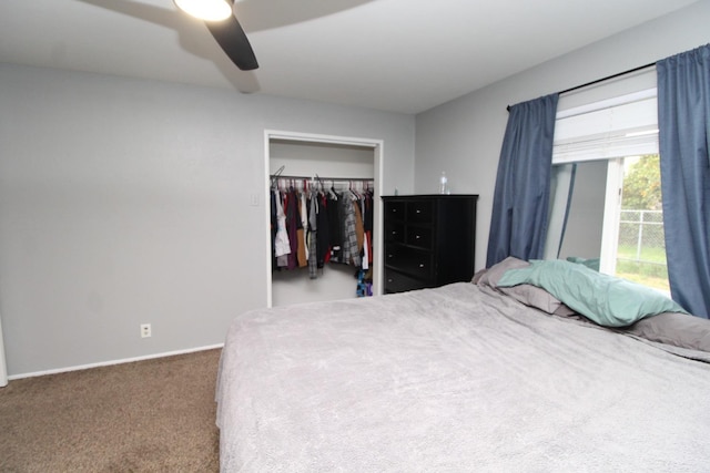 carpeted bedroom with a closet, baseboards, and ceiling fan