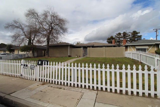 single story home with a fenced front yard, stucco siding, a front lawn, and a gate