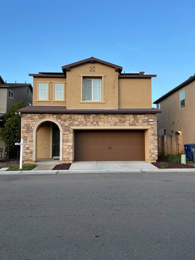 view of front of home with fence and stucco siding