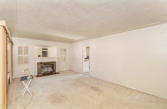 unfurnished living room with a brick fireplace, a textured ceiling, and carpet flooring