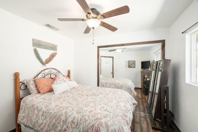 bedroom with dark wood finished floors, visible vents, and a ceiling fan