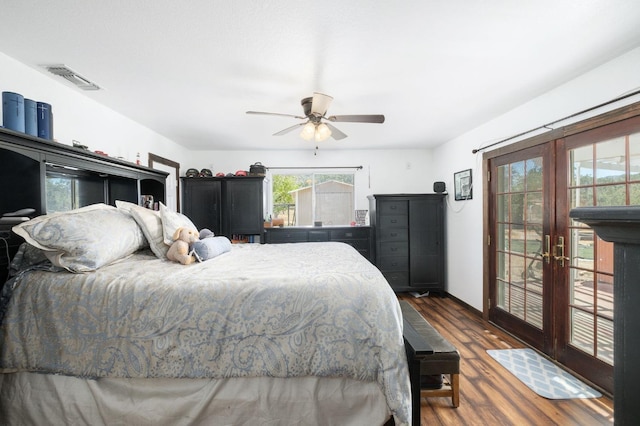 bedroom with ceiling fan, wood finished floors, visible vents, access to outside, and french doors