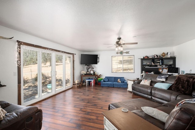 living area featuring a ceiling fan, a textured ceiling, and hardwood / wood-style floors