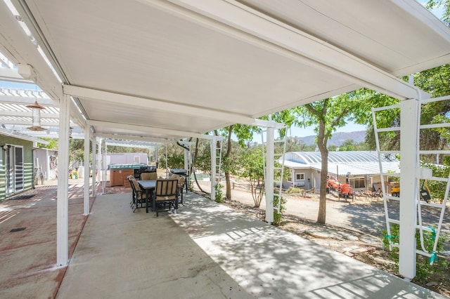 view of patio / terrace with outdoor dining space and a hot tub