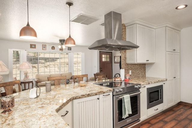 kitchen with island exhaust hood, pendant lighting, stainless steel appliances, and backsplash