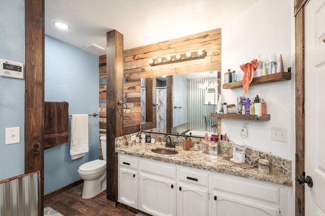 full bath with wood finish floors, toilet, wood walls, vanity, and a shower with curtain