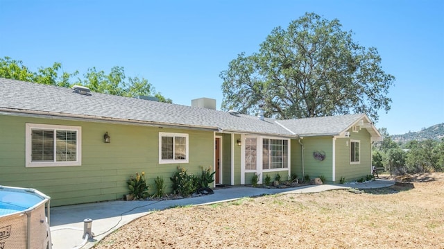 ranch-style home with a shingled roof