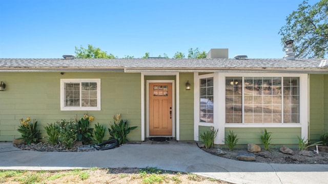 property entrance with roof with shingles