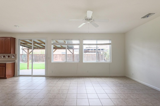 unfurnished room featuring light tile patterned floors, plenty of natural light, and visible vents