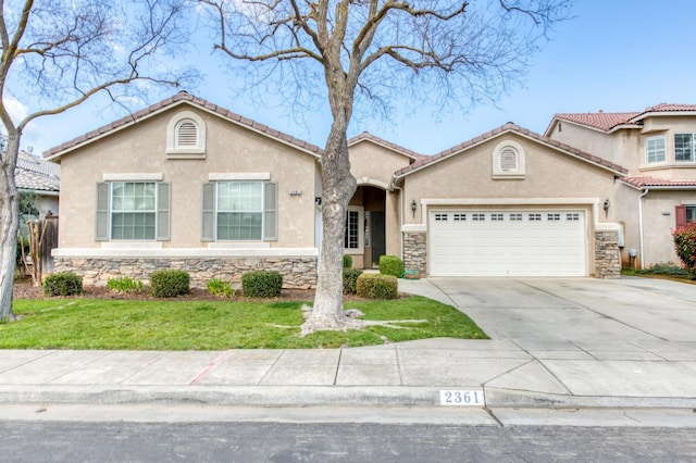 mediterranean / spanish home with stone siding, driveway, an attached garage, and stucco siding