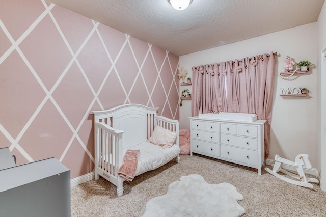 bedroom featuring a textured ceiling and carpet flooring