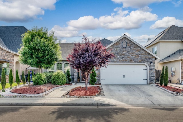 view of front of house featuring a garage, stone siding, and concrete driveway