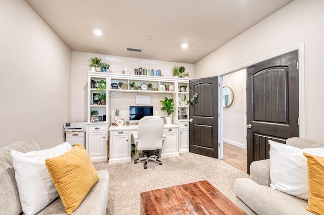 office area with light colored carpet and visible vents