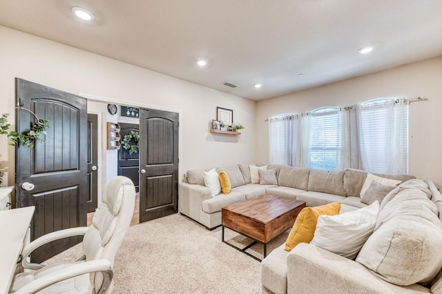 living area with carpet flooring, visible vents, and recessed lighting