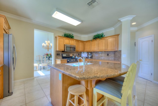 kitchen featuring light tile patterned floors, visible vents, a sink, stainless steel appliances, and backsplash