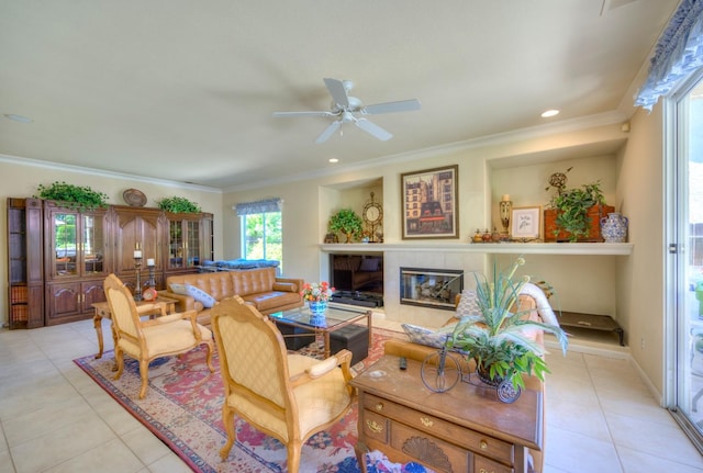 living room featuring light tile patterned floors, ornamental molding, and a tile fireplace