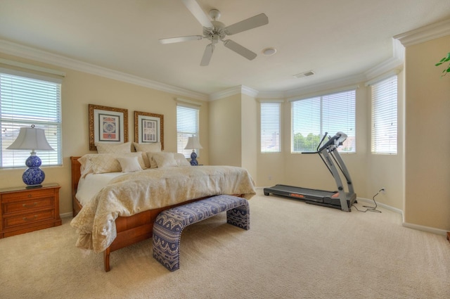 carpeted bedroom with ornamental molding, multiple windows, visible vents, and a ceiling fan